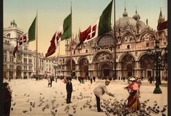 Alcune persone intente a nutrire i piccioni in Piazza San Marco con dietro la Basilica (Library of Congress - Detroit Publishing Company).
